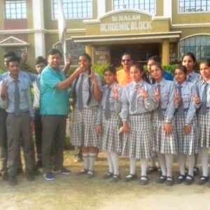 विद्यालय के चेयरमैन अभिषेक कुमार बच्चे को मिठाई खिलाते हुए